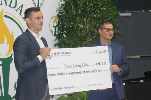 Lee Pinchouck, the executive director of The Foundation for Florida Gateway College (right), and Noah Walker, the foundation board’s president presented a check to the college for nearly $1.2 million on Wednesday for scholarships and program enhancement. (TONY BRITT/Lake City Reporter)