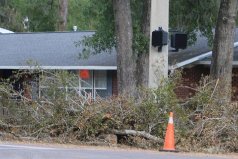 Storm debris is piled up alongside SW McFarlane Avenue in Lake City on Monday afternoon. Cleanup crews will now begin the process of picking up the debris alongside streets and roadways in both the City of Lake City and Columbia County. (JACK WACHTER/Lake City Reporter)