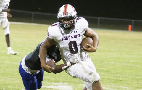 Fort White running back Lecosta Byrd shakes off a tackle against Belleview last Friday. (MORGAN MCMULLEN/Lake City Reporter)