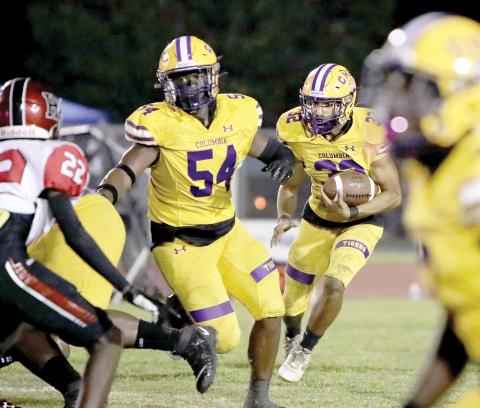 Columbia running back TC Smith follows a block from Issac Kimble against Hillsborough on Friday night. (BRENT KUYKENDALL/Lake City Reporter)