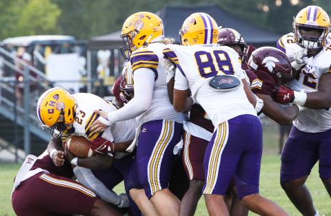 Columbia running back Johnathan Andrews fights for yardage as center Zackery Grimes (middle), tight end Aaron Holmes (88) and right guard Chase Johnson (72) try to block Coffee defenders on Friday. (BRENT KUYKENDALL/Lake City Reporter)