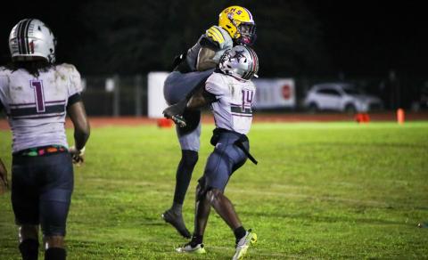 Columbia receiver Kyren Caldwell gets wrapped up by Madison County defensive back Sean Williams following a catch on Friday. (BRENT KUYKENDALL/Lake City Reporter)