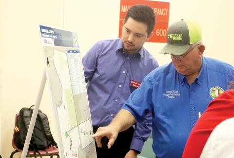Columbia County Commissioner Everett Phillips (right) and Kimley-Horn’s Raul Pineda-Mendez look over a map of the Columbia County Comprehensive Safety Action Plan during an open house Thursday. (MORGAN MCMULLEN/Lake City Reporter)