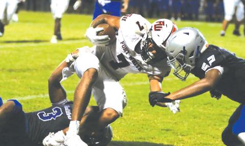 Fort White receiver Tafari Moe gets gang tackled after a catch Friday against Belleview. (MORGAN MCMULLEN/Lake City Reporter)