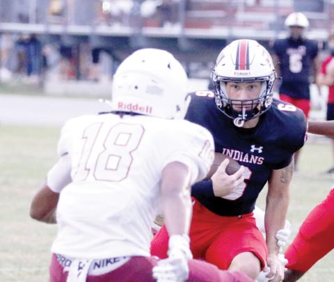 Fort White running back Hayden McCrory eyes a North Marion defender on a run Friday night. (MORGAN MCMULLEN/Lake City Reporter)