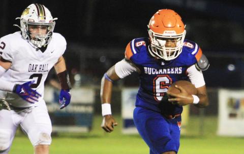 Branford quarterback Damian Herrera scrambles up the field against Oak Hall on Aug. 23. (PAUL BUCHANAN/Lake City Reporter)