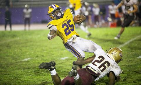 Columbia running back Jerome Horne is tackled St. Augustine defensive back Marquell Elmore on Wednesday night. (BRENT KUYKENDALL/Lake City Reporter)