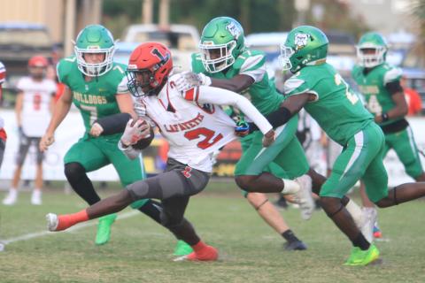 Lafayette receiver Jordan Murphy tries to pull away from Suwannee defenders JaDarius Horne (2), Travis Fead (17) and Jace Moran (7) last Friday. (PAUL BUCHANAN/Lake City Reporter)