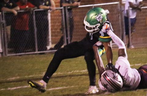 Suwannee running back Lou Jack Smith is tackled for a loss by Madison County’s Kemari Scurry on Friday. (JAMIE WACHTER/Lake City Reporter)