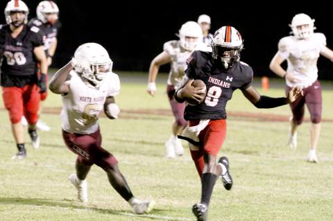 Fort White quarterback Jayden Jackson scrambles against North Marion last Friday night. (MORGAN MCMULLEN/Lake City Reporter)