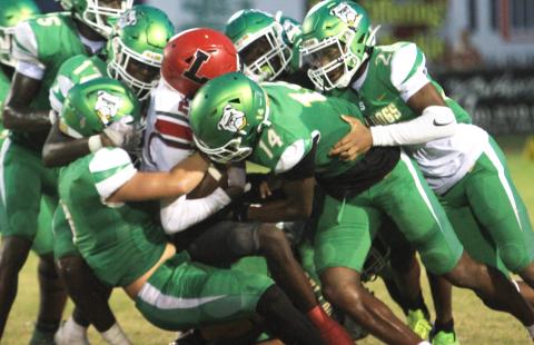 Suwannee’s defense swarms to tackle Lafayette receiver Jordan Murphy last Friday. (PAUL BUCHANAN/Lake City Reporter)