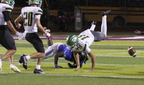 Godby’s Qyntrel Strong upends AJ Hitt after a bad punt snap in the fourth quarter of Friday’s game. (JAMIE WACHTER/Lake City Reporter)