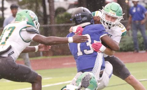 Suwannee safety Kamden Lang tackles Godby quarterback Lazarus Chambers last Friday. (JAMIE WACHTER/Lake City Reporter)