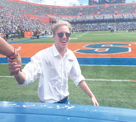 Florida Mic Man Drew Hingson, 19, of Lake City, greets Gator fans in the student section at The Swamp on Saturday. Hingson, was selected for the Mic Man job 10 days before the home opener and joined the Florida Cheer Squad after an open tryout on campus. He is a sophomore at UF. (COURTESY)