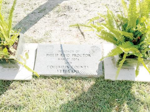 A marker honoring Philip Proctor and other Columbia County veterans rests at the base of the 35-foot flag pole at the Columbia County Veterans Park dedicated Monday by the American Legion Post 57. (JAMIE WACHTER/Lake City Reporter)