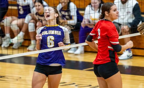 Columbia hitter Sinei Wood (6) celebrates a point while Lafayette middle blocker Sophia Kendrick (9) looks on during Tuesday’s match. (JACK HOWDESHELL/Lake City Reporter)