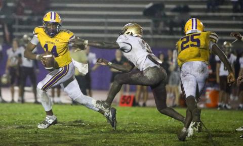 Columbia quarterback Xavier Collins runs away from pressure applied by St. Augustine defensive back Braylon James on Sept. 25. (BRENT KUYKLENDALL/Lake City Reporter)