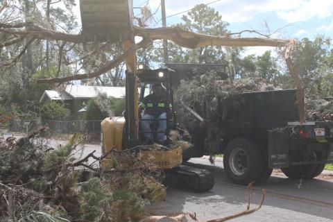 A Lake City Public Works employee helps clear debris from the roadside left in the wake of Hurricane Helene. Lake City Executive Director of Utilities Steve Brown, who also oversees public works, said additional crews have been brought in to help with the effort. (TONY BRITT/Lake City Reporter)