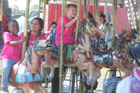 De’Mari Jackson (from left), Mya Villar and Parker Spin, are all smiles while riding the carousel Tuesday morning at the Florida Gateway Fair. (TONY BRITT/Lake City Reporter)