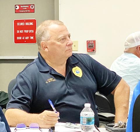 Lake City Police Department Chief Gerald Butler listens to reports from agencies during Tuesday morning’s briefing at the Emergency Operations Center. Butler said his department would be increasing the number of officers on the streets to protect businesses and evacuees parked randomly around the city waiting out Hurricane Milton. (TODD WILSON/Lake City Reporter)