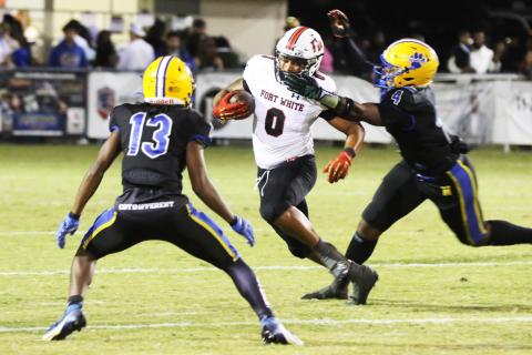 Fort White running back Lecosta Byrd gets his facemask grabbed by Newberry linebacker Logan Mccloud on Friday night. (MORGAN MCMULLEN/Lake City Reporter)