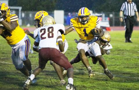 Columbia receiver Zamarion Jones tries to escape a tackle from St. Augustine defensive back Braylon James (3) on Sept. 25. (BRENT KUYKENDALL/Lake City Reporter)