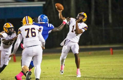 Columbia quarterback Xavier Collins throws a pass under pressure against Clay on Friday night. Collins finished with four touchdown passes. (BRENT KUYKENDALL/Lake City Reporter)