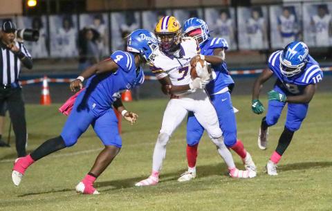 Columbia receiver Kyren Caldwell catches a touchdown pass while surrounded by Clay defenders during his team’s 49-13 win Friday. (BRENT KUYKENDALL/Lake City Reporter)