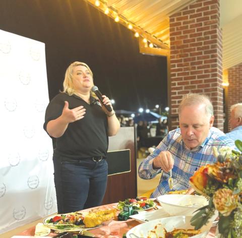 U.S. Rep. Kat Cammack (R-Gainesville) speaks during Thursday’s Farm To Table fundraiser as Ag Commissioner Wilton Simpson dines on chicken pot pie. (COURTESY)