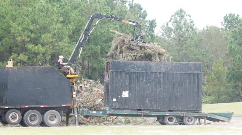 A contractor uses a mechanical lift to remove debris from the buckets of his truck on Tuesday afternoon at Columbia County Public Works. There are five double trucks that are going around the county collecting the organic debris that’s on county right-of-way. (TONY BRITT/Lake City Reporter)