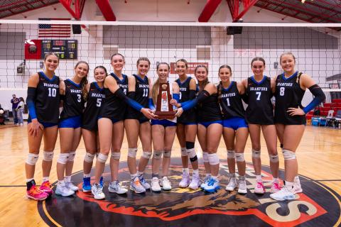 Branford's volleyball team poses with the District 6-R trophy after sweeping Union County on Thursday night. (JACK HOWDESHELL/Lake City Reporter)