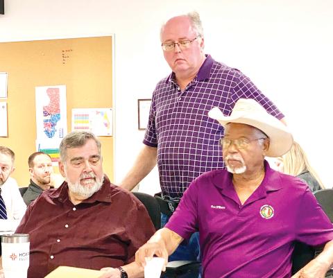 County Manager David Kraus (from left), Emergency Management Director Shayne Morgan and County Commissioner Ron Williams discuss Hurricane Milton prior to an emergency meeting Wednesday morning. (TODD WILSON/Lake City Reporter)