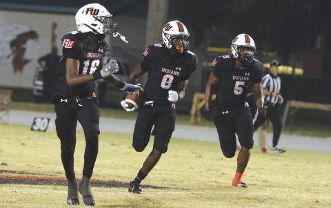 Fort White’s Jayden Jackson (8) looks for room to run on his first interception return for a touchdown Friday against Hilliard as DeSean Lally (16) and Darion Brinson (5) look to make a block. (MORGAN MCMULLEN/Lake City Reporter)