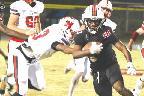 Fort White running back Elijah Gardner runs through the Hilliard defense last Friday. (MORGAN MCMULLEN/Lake City Reporter)