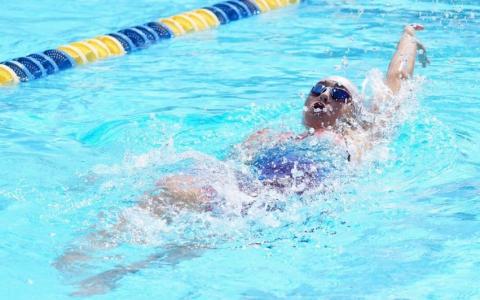 Columbia swimmer Casey Fair competes in the 100 backstroke at the District 2-3A meet on Tuesday. She won the event to qualify for regionals. (JODY SHEEHAN/Special to the Reporter)