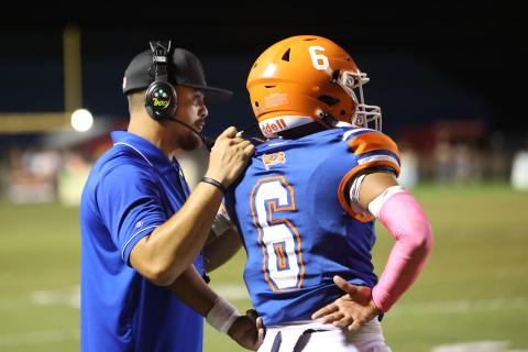 Branford head coach Tim Clark (left) talks to quarterback Damian Herrera during last Friday’s game against Trenton. (PAUL BUCHANAN/Lake City Reporter)