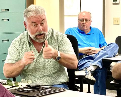 Columbia County Assistant County Manager Kevin Kirby (left) explains the need for an amended contract with storm cleanup contractors during an emergency county commission meeting Thursday morning. Commissioners unanimously approved the measure. Emergency Management Director Shayne Morgan is in the background. (TODD WILSON/Lake City Reporter)