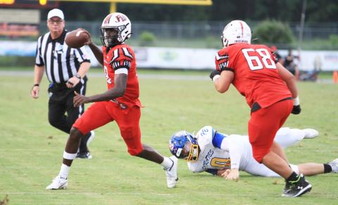 Fort White quarterback Jayden Jackson scrambles away from pressure against Fernandina Beach on Sept. 13. (PAUL BUCHANAN/Lake City Reporter)