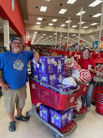 Kids Feeding Kids President John Cole (left) displays the items he got from Target to donate to victims of Hurricane Helene. (COURTESY)