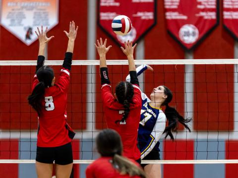 Columbia hitter Kayla Goodloe fires a shot at Lafayette's Kiley Beach (8) and Libby Beach (7) on Sept. 24. (JACK HOWDESHELL/Lake City Reporter)
