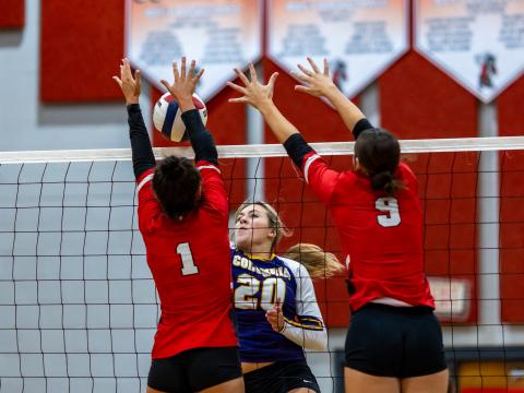 Columbia middle hitter Cassidy O'Neal fires a shot at Lafayette's Brooke Lamb (1) and Sophia Kendrick (9) on Sept. 24. (JACK HOWDESHELL/Lake City Reporter)