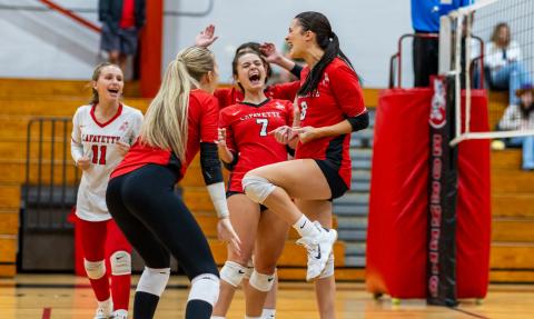 Lafayette volleyball players Ella McAdams (11), Havyn Richardson (middle left), Libby Beach (7) and Kiley Beach (8) celebrate after scoring a point against Columbia on Sept. 24. (JACK HOWDESHELL/Lake City Reporter)