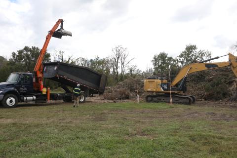 A Lake City Public Works truck gets set to dump debris onto an existing pile at the Public Works lot on NE Gum Swamp Road Friday afternoon. (MORGAN MCMULLEN/Lake City reporter)