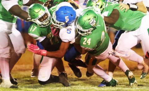 Suwannee linebacker Travis Fead (17) and defensive end Kyler Watson (24) tackle Taylor County running back Dj McCoy last Friday. (PAUL BUCHANAN/Lake City Reporter)