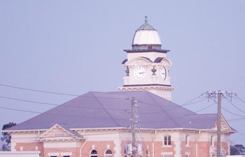 The Suwannee County Courthouse was damaged by Hurricane Helene last month with two of the four clock faces knocked out and copper peeled off the dome. Temporary repairs have been done to the dome and the renovation work received a donation this week from the Sons of the American Revolution’s Lake City chapter. (JAMIE WACHTER/Lake City Reporter)