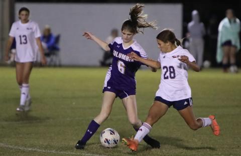 Columbia's Niki Sossie dribbles while defended by Wakulla's Hadley Brown on Thursday night. (BRENT KUYKENDALL/Lake City Reporter)