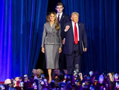 Republican presidential nominee former President Donald Trump arrives to his election night party alongside his wife, Melania Trump, and his son, Barron Trump, at the Palm Beach County Convention Center on Tuesday in West Palm Beach. (MATIAS J. OCNER/Miami Herald/MCT)