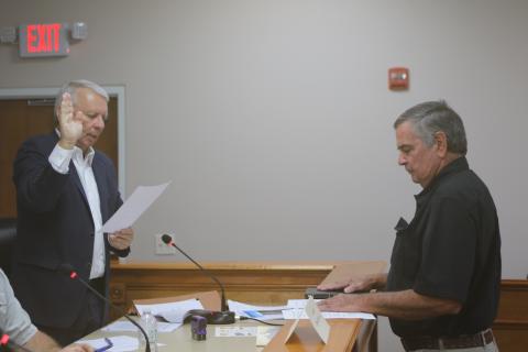 Grady Williams (from left), North Florida Water Utilities Authority Board of Directors legal counsel, swears in Steven Dicks as the board member at-large for the entity. (TONY BRITT/Lake City Reporter)