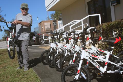 Mike Kelley, the vice president of the Suwannee Bike Association, lines up bicycles that the group donated to the Columbia County Toys for Tots program last week. The bicycle group has contributed to Toys for Tots for three years. (TONY BRITT/Lake City Reporter)