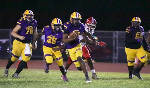Columbia quarterback Xavier Collins scrambles up the field against North Miami Beach on Nov. 1. (BRENT KUYKENDALL/Lake City Reporter)